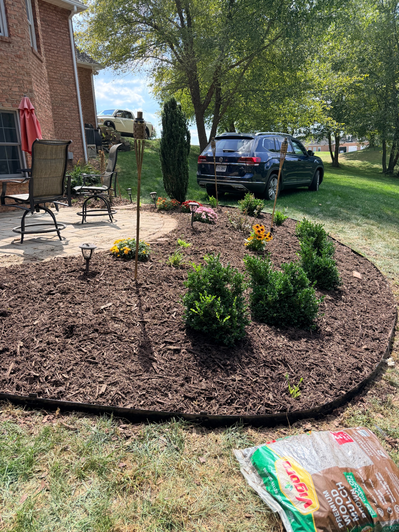 Freshly installed mulch bed with shrubs and flowers